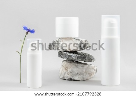 Set of cosmetic for skin care face, body. White blank cosmetics bottles, jar and stones on grey background. Natural Organic Spa Cosmetic Beauty Concept Mockup Front view.