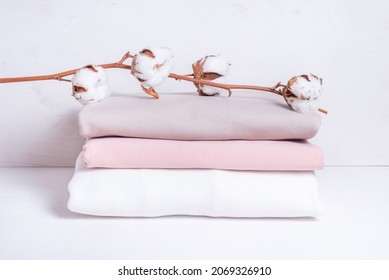 Set of cotton fabric with cotton flower branch on wooden backgro