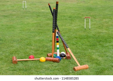 Set of croquet mallets and balls in the garden