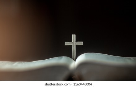 Set the Cross in the middle of the Bible. - Shutterstock ID 1163448004