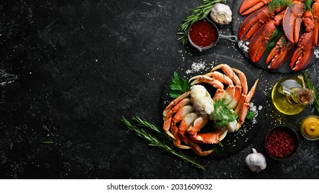 Set of crustaceans. Boiled crab claws and lobster. Rustic style. Seafood delicacies.
