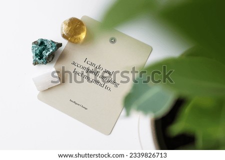 A set of crystals laying down on an affirmation card.