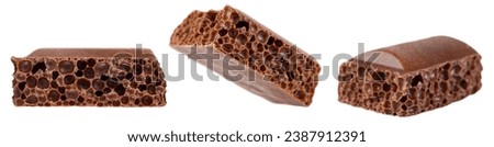 Set of cubes of milk porous chocolate isolated on a white background.