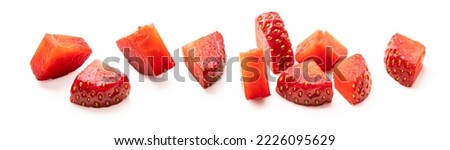 Set of cut strawberry pieces isolated on white background. Chopped strawberry close up. Collection of small pieces of fresh strawberries on white.