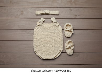 Set Of Cute Baby Knitwear For Photoshoot On Wooden Background, Flat Lay