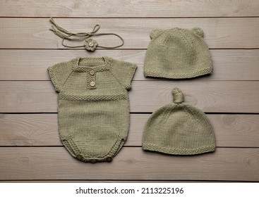 Set Of Cute Baby Knitwear For Photoshoot On Wooden Background, Flat Lay