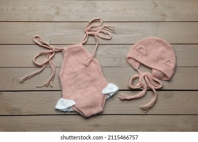 Set Of Cute Baby Knitwear For Photoshoot On Wooden Background, Flat Lay