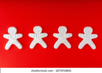  Set of cute cartoon gingerbread man cookies. Creative Holiday concept. White toys on red background.  - Powered by Shutterstock