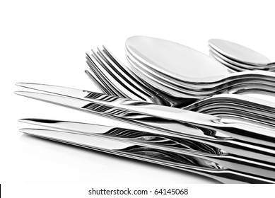 a Set of cutlery with stacked knifes, forks, spoons and tea spoons on a white background with space for text - Powered by Shutterstock - Get 15% off with code: PIKWIZARD15