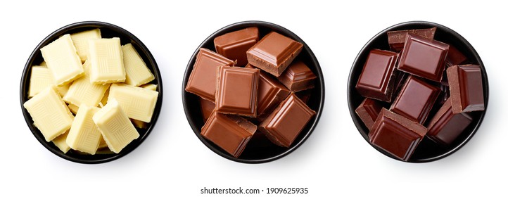 Set of dark, white and milk chocolate pieces in bowl isolated on white background, top view - Powered by Shutterstock
