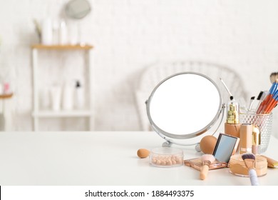 Set of decorative cosmetics and mirror on dressing table
