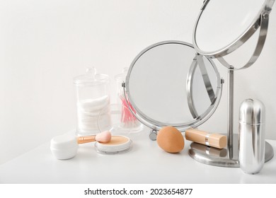 Set of decorative cosmetics and mirrors on dressing table