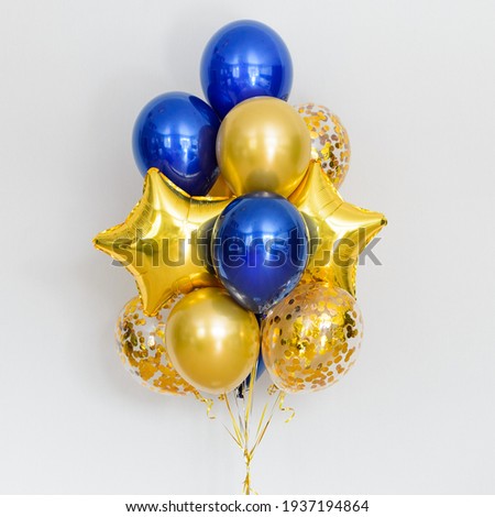 Set of deep blue and gold helium balloons