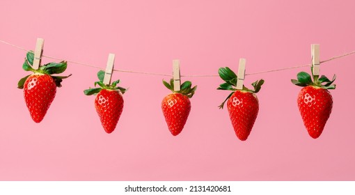 Set Of Delicious Red Strawberries Hung On A String With A Pin