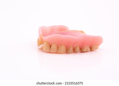 A Set Of Dentures And False Teeth Isolated On A White Background