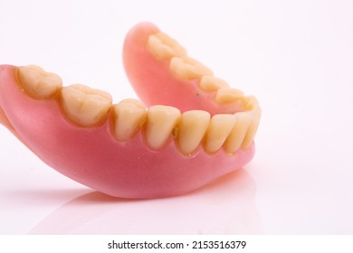 A Set Of Dentures And False Teeth Isolated On A White Background