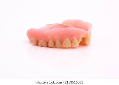 A Set Of Dentures And False Teeth Isolated On A White Background