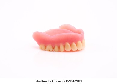 A Set Of Dentures And False Teeth Isolated On A White Background