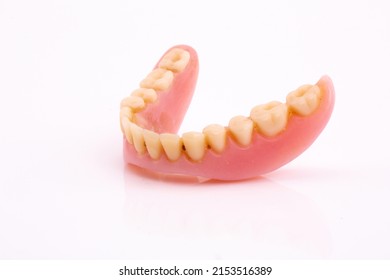 A Set Of Dentures And False Teeth Isolated On A White Background