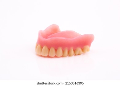 A Set Of Dentures And False Teeth Isolated On A White Background