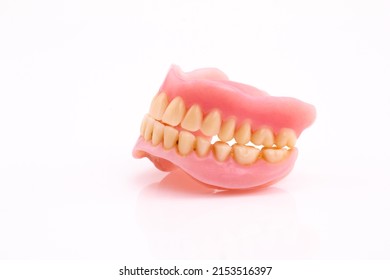 A Set Of Dentures And False Teeth Isolated On A White Background