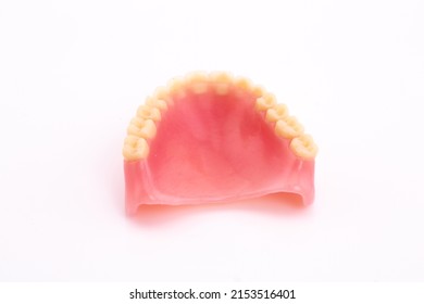 A Set Of Dentures And False Teeth Isolated On A White Background