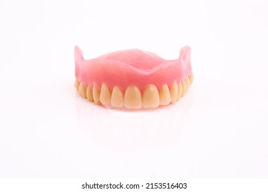 A Set Of Dentures And False Teeth Isolated On A White Background