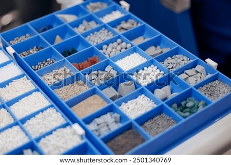 Set of different abrasive particles for grinding metal parts.
