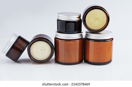 A set of different aroma candles in glass jars on a white background. Scented handmade candle. Soy, wax and paraffin candles. - Shutterstock ID 2142378469