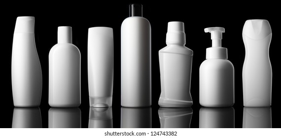 Set Of Different Bottles For Beauty, Hygiene And Health On A Black Background With Reflection, They Shampoo, Conditioner And Other Hair Products, Each Of Them Shot On Separately.