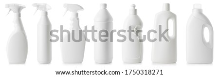 Set of different bottles of cleaning products in a row isolated on white background