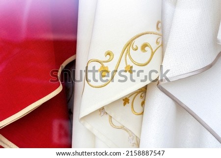 Set of different catholic church priest chasubles, vestments, traditional robes, priest's religious clothing, clothes simple concept, detail, extreme closeup, nobody. Christianity, catholic culture
