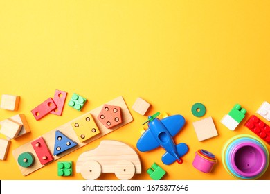 Set of different children's toys on a colored background top view. A place to insert text, minimalism. Baby background.
