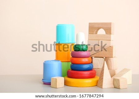 Set of different children's toys on a colored background. A place to insert text, minimalism. Baby background.
