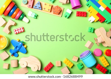 Set of different children's toys on a colored background top view. A place to insert text, minimalism. Baby background.
