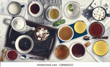 Set Of Different Cold Drinks And Hot Drinks - Juices, Coffee, Tea, Milk, Mint Water - Cups And Mugs Served On White Wooden Table. Closeup. Top View.