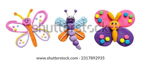 Set with different colorful plasticine butterflies on white background, top view