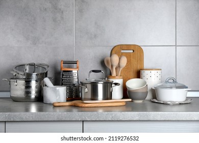 Set of different cooking utensils on grey countertop in kitchen - Shutterstock ID 2119276532