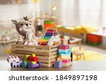 Set of different cute toys on wooden table in children
