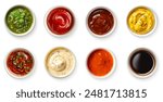 Set of different dip sauces top view. Bowls of many dipping sauces isolated on white background. pesto, ketchup, bbq sauce, mustard, marinara sauce, ranch, romesco, soy sauce. Different sauces set.