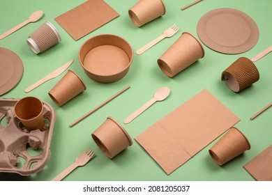 Set of different eco-friendly tableware and kraft paper food packaging on green background. Street food paper packaging - cups, plates, straws, containers, paper bags and wooden cutlery. Mockup - Shutterstock ID 2081205037
