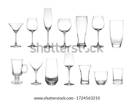 Set of different empty glasses on white background