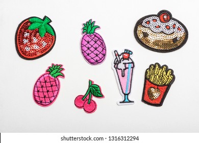 Set of different fabric patches isolated on white. Fruits, cocktail and French fries. Craft supplies for clothing refashion.