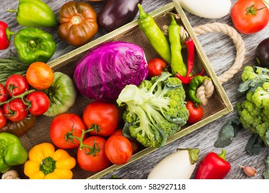 Set of different fresh raw colorful vegetables in the wooden tray, light background - Powered by Shutterstock