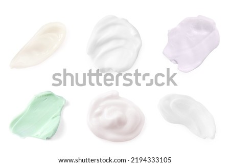 Set of different hand creams samples on white background, top view