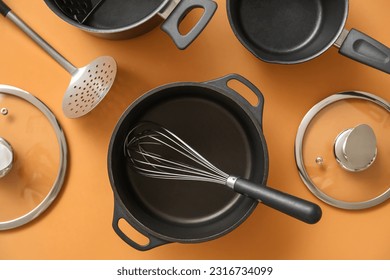 Set of different kitchen utensils on orange background - Shutterstock ID 2316734099
