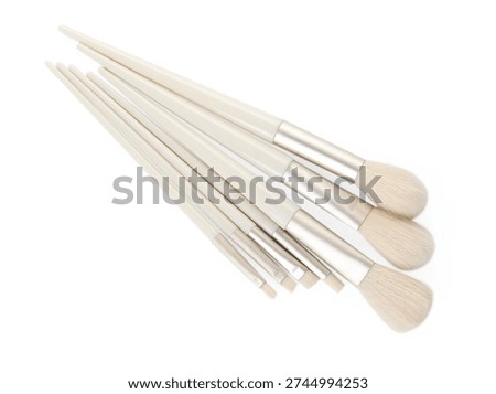 Set of different makeup brushes isolated on white, top view