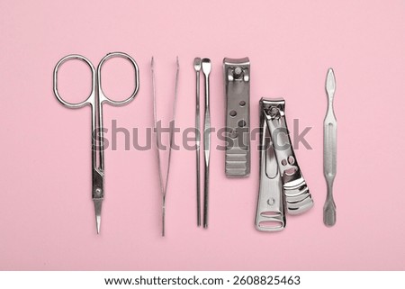 Set of different manicure tools on pink background, flat lay