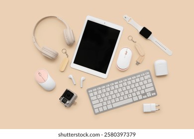 Set of different modern gadgets with tablet computer on color background