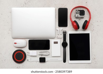 Set of different modern gadgets with tablet computer on light background